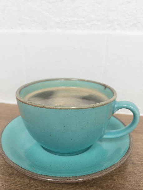 istock Single aqua blue cup and saucer of coffee 2210081603