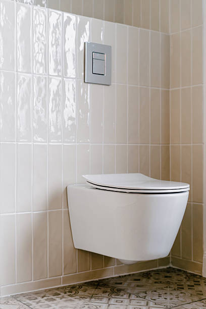 istock Modern toilet bowl design in minimalist restroom with white tiled wall 2210081767
