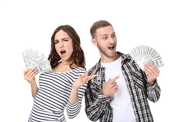 istock Young couple with dollar banknotes isolated on white background 2210082616
