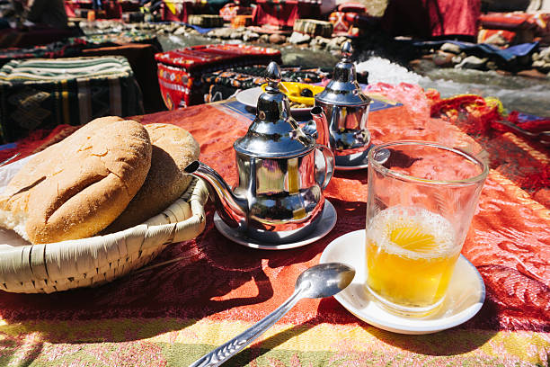 istock Traditional mint tea. Moroccan drink moment. Silver teapot shine. Fresh bread breakfast. River picnic vibes. 2210085178