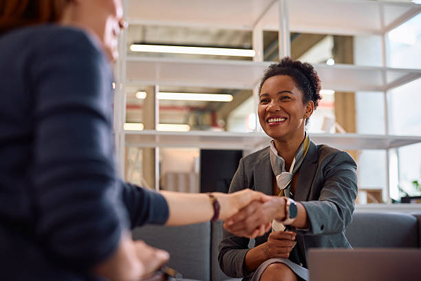 istock Happy black financial consultant shaking hands with her client in the office. 2210086052