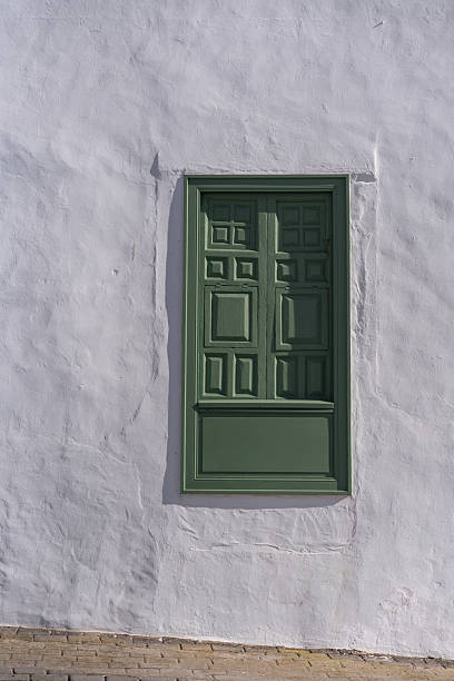 istock Old vintage green window on a white wall 2210087023