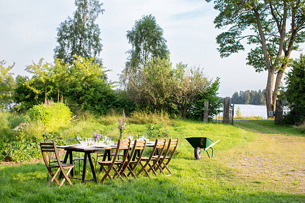 istock Long Outdoor Dining Table in Lush Swedish Garden 2210088277