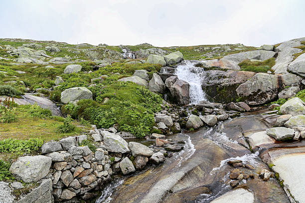 istock A rocky stream with a waterfall flowing over it Alps 2210090528