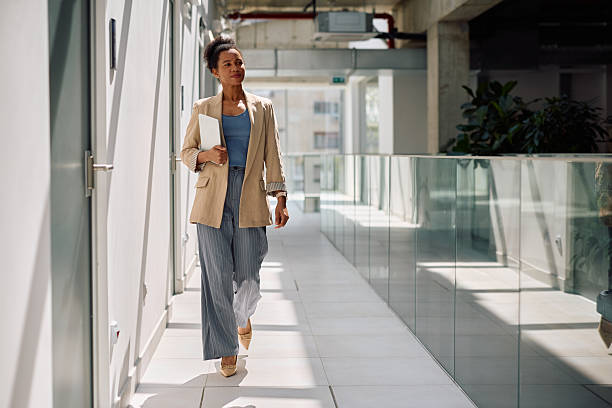 istock Black female CEO walking through an office building. 2210091235