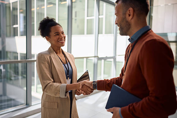 istock Happy black CEO shaking hands with her colleague in the office. 2210091254
