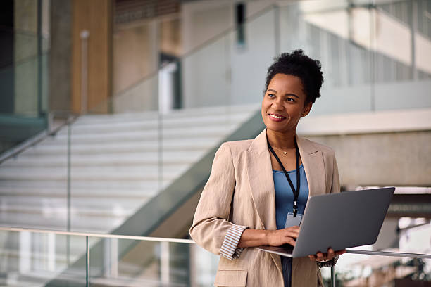istock Happy female corporate manager using laptop while working in the office. 2210091304