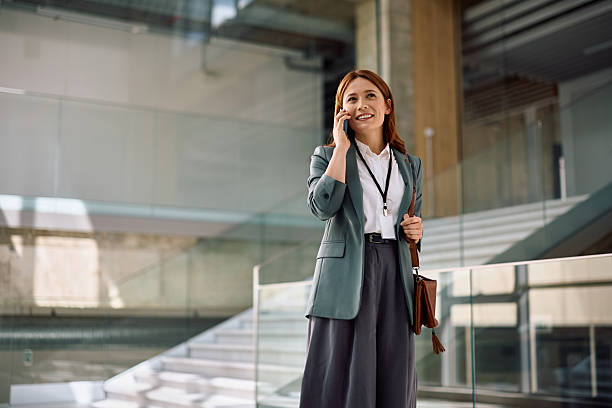 istock Happy corporate manager communicating over her smartphone in the office. 2210091383