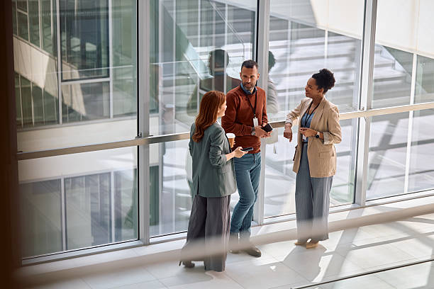 istock Business coworkers talking on a coffee break in the office. 2210091472