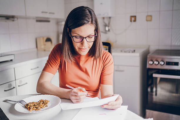 istock The woman professor looking at the students' work while eating lunch 2210101460