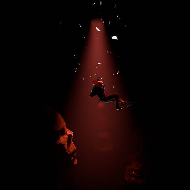 istock A man falls into a dark abyss surrounded by giant zombie heads and skulls, symbolizing falling into fear. 2210116010