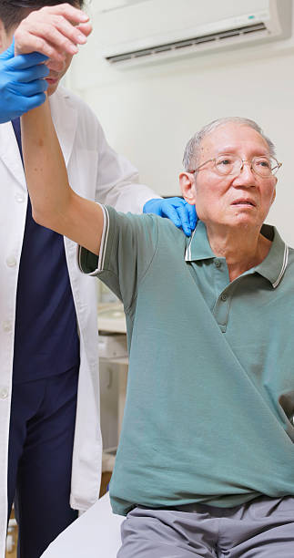 istock Asian Therapist Aids Arm Recovery 2210122096