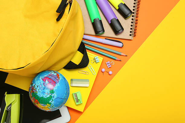 istock School backpack and stationery on color background, flat lay. Space for text 2210122909