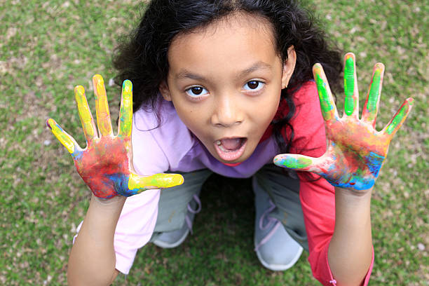 istock Indonesian Kids Playing with Water Color on Her Hand 2210126632