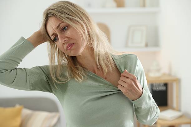 istock Menopause. Woman suffering from hot flash at home 2210129614