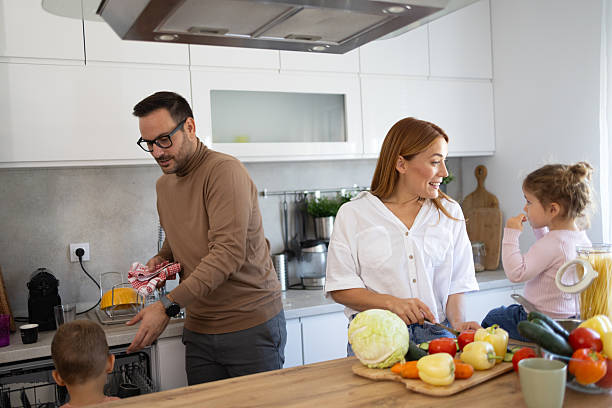 istock Couple Sharing Moments in Kitchen with Their Children 2210130594