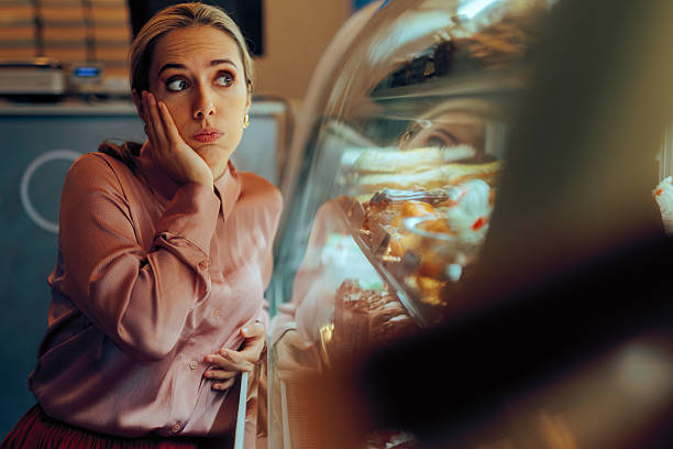 istock Customer Feels Guilty When Looking at the Cakes in the Window 2210132428