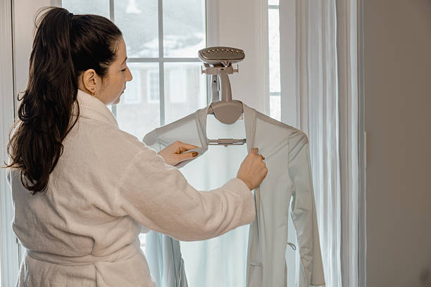 istock A woman is hanging her clothes on a clothesline 2210134609