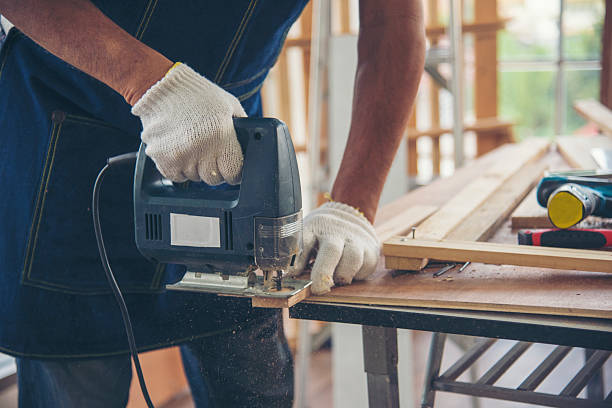 istock DIY craftsperson asian man working wood heap carpenter objects woodwork desk. Architect man hands use ruler measure hammer home improvement. Wooden builder carpenter repairing construction workshop 2210139108