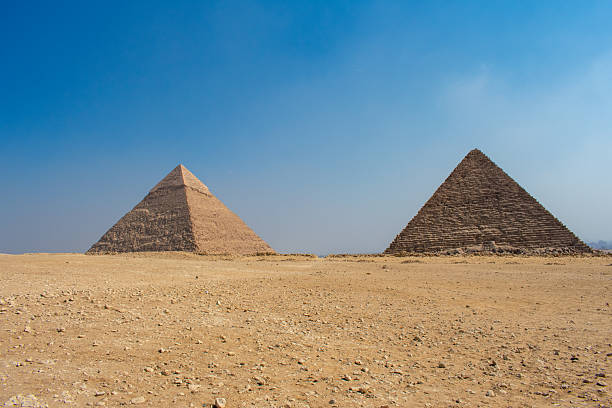istock Great Sphinx and Great Pyramid of Cheops, Cairo, Egypt. Ancient statue of Sphinx, mythical creature with head of man and body of a lion, Giza pyramid complex (Giza Necropolis) 2210140573