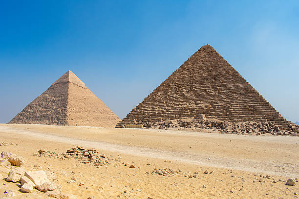 istock Great Sphinx and Great Pyramid of Cheops, Cairo, Egypt. Ancient statue of Sphinx, mythical creature with head of man and body of a lion, Giza pyramid complex (Giza Necropolis) 2210140585