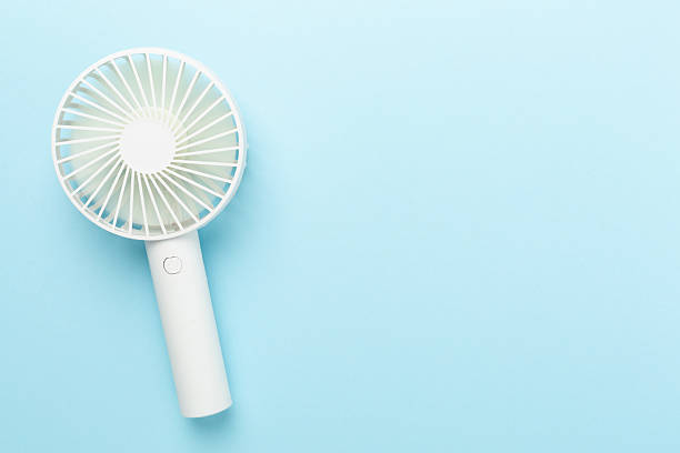 istock Mini electric fan on color background, top view 2210140758