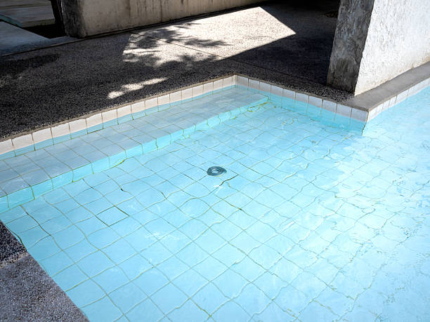 istock Swimming pool steps with clear water surface background, with nobody. Abstract pool texture, underwater pattern light blue background with grid tiles inside concrete building. Summer background. 2210153198