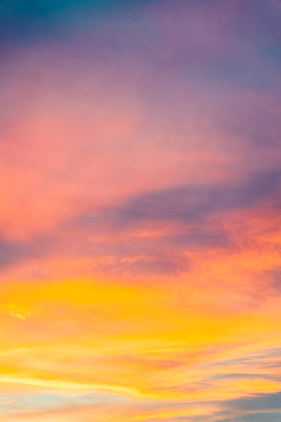 istock Colorful twilight sunset sky with vibrant orange and pink clouds, blending into soft blue. 2210155583
