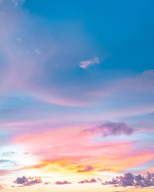istock Stunning sunset with colorful clouds painted in pink and orange against a soft blue backdrop. 2210155690