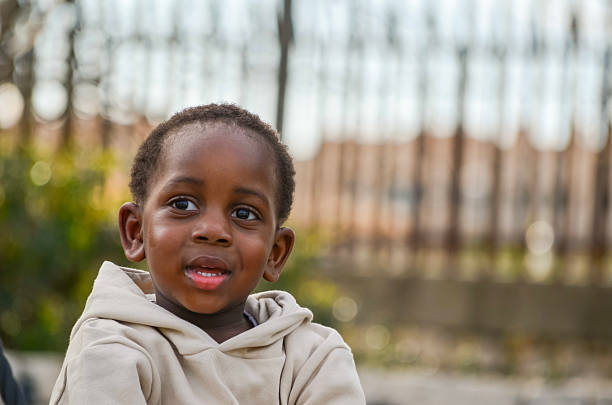 istock Portrait of smiling young boy looking away from camera 2210156684