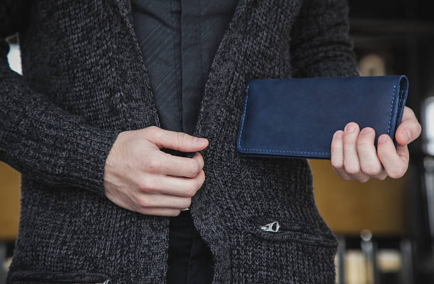 istock male holding blue wallet in stylish attire 2210157493