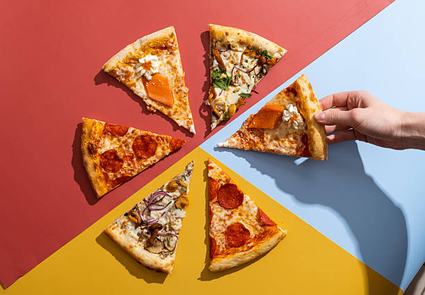 Variety of delicious pizza slices on colorful background with hand