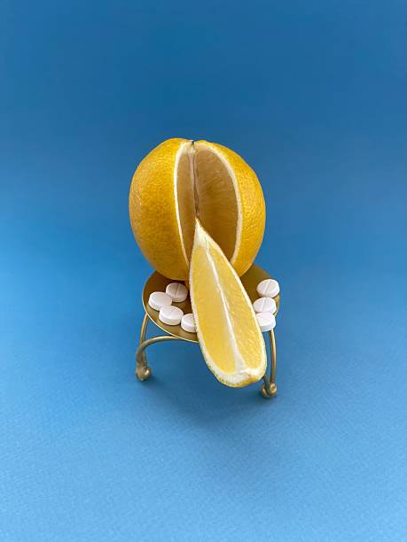 istock Lemon and pills on miniature chair against blue background 2210159628