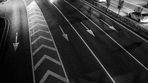 istock Multiple Highway Lanes with Directional Arrow Markings and Chevron Safety Signage 2210161402
