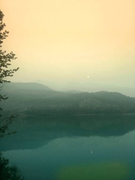 Smoky Sunset Over Mountain Lake Reflections