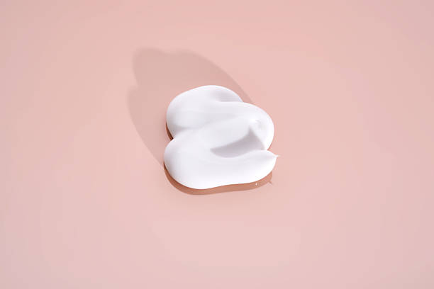 istock The texture of white cream on a pink background. 2210162404