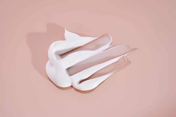 istock The texture of white cream on a pink background. 2210162732