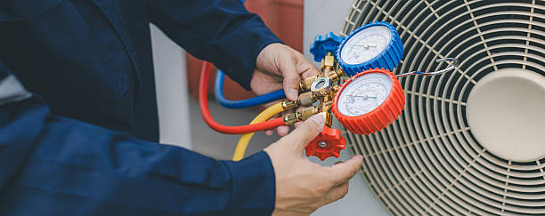 istock Technician is checking air conditioner. Air conditioning, HVAC service technician using gauges to check refrigerant and add refrigerant. 2210162860