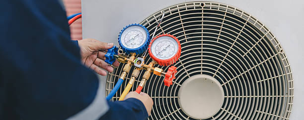 istock Technician is checking air conditioner. Air conditioning, HVAC service technician using gauges to check refrigerant and add refrigerant. 2210162866