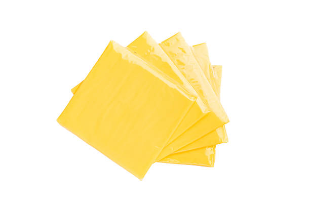 istock Square  Slices of processed Cheddar cheese in individual plastic packaging isolated on white background 2210168106