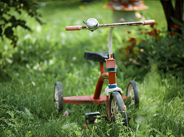 Lots of tricycles and wheeled toys at a playground near Hamilton, Ontario, Canada, on a sunny day.