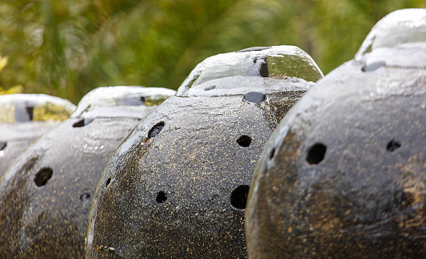 istock A row of black ceramic vases with holes in them 2210168796