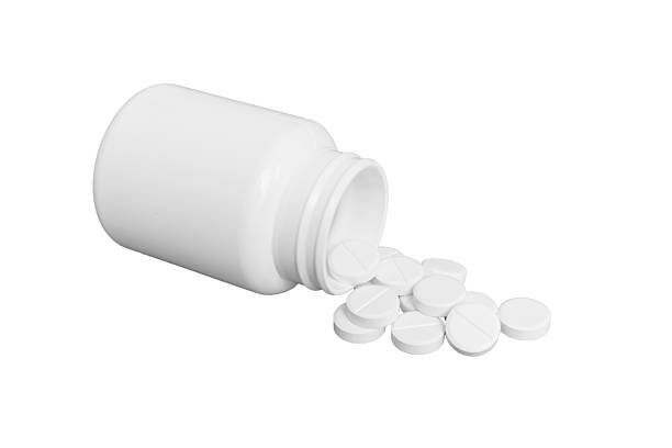 istock White medicines flow from container. medicine white pill bottle isolated on a white background 2210168916