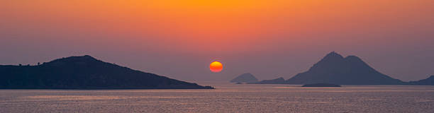 Sunset or sunrise over the sea with islands banner