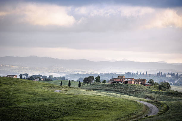 istock Tuscan Farmhouse on a Hillside with Misty Valley View 2210172548