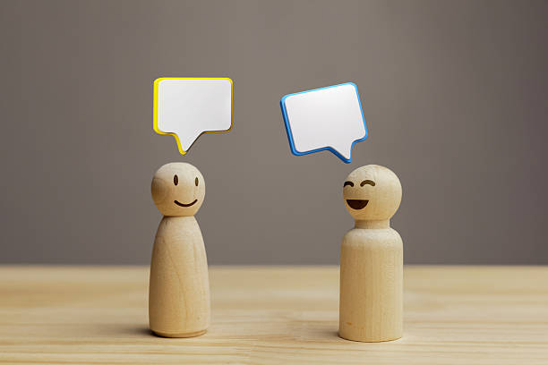 istock Customer negotiations with service provider. Two wooden dolls with speech bubbles. 2210174833