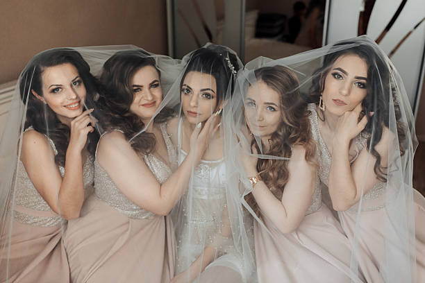 istock A group of five women are sitting under a white veil 2210174870