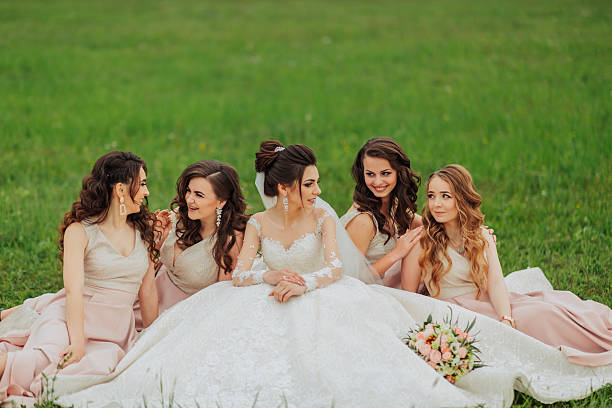 istock A group of five women are sitting on the grass 2210174996