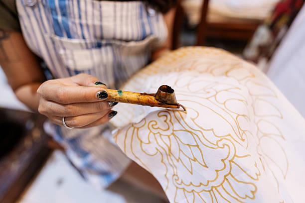 istock Close Up of Young Woman Practicing Traditional Batik Waxing Technique 2210175644