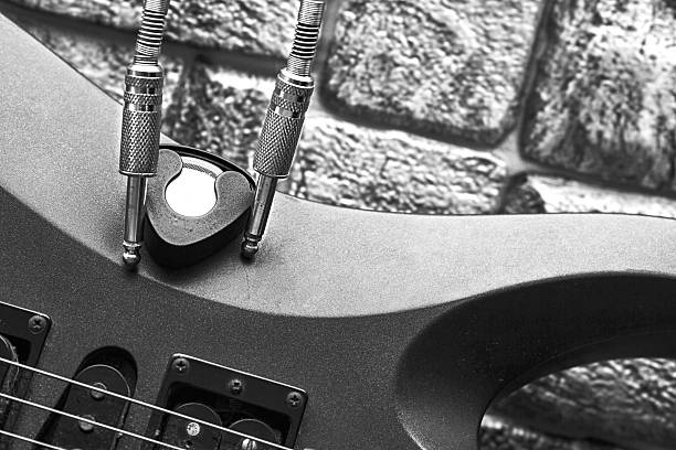Young man playing his guitar. Studio shot with photographic effect.